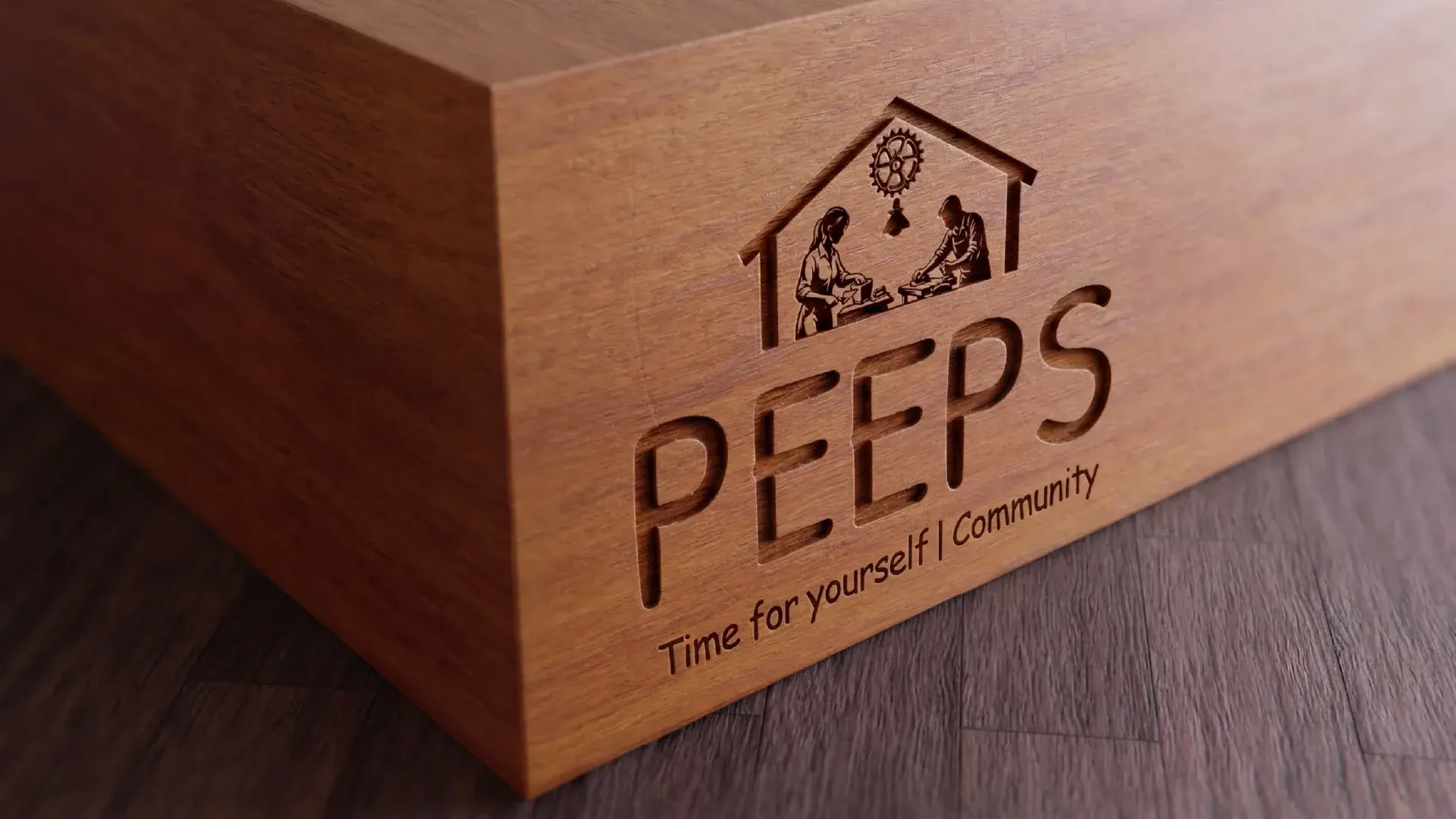 The Peeps logo engraved on a wooden box